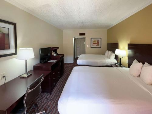 a hotel room with a large bed and a television at Motel 6 Dallas TX Downtown in Dallas