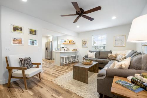 a living room with a couch and a ceiling fan at B Street Bungalow in Bentonville