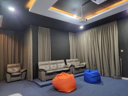 a waiting room with two chairs and curtains at MP Villa with Cinema Room in Hock Lam Village
