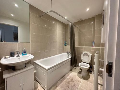 a bathroom with a sink and a tub and a toilet at 1 stop to London Bridge in London
