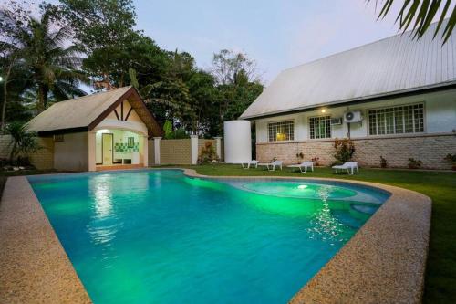 a swimming pool in front of a house at Panglao villa family reunions in Panglao