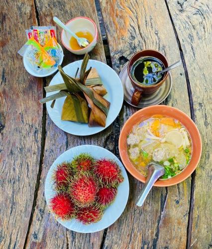 a table with plates of food and bowls of food at Numpu Baandin in Sam Roi Yot