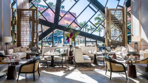 a restaurant with tables and chairs and a large glass ceiling at Jewel Broadbeach Luxury Apartment - CoastHM in Gold Coast