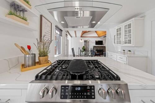 a kitchen with a stove top in a white kitchen at Charming Hillcrest/Mission Hills 3 BR + House in San Diego