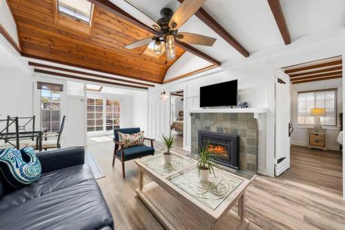 a living room with a fireplace and a ceiling fan at Charming Hillcrest/Mission Hills 3 BR + House in San Diego
