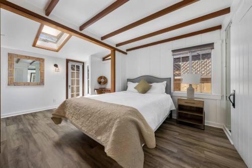 a white bedroom with a bed and a window at Charming Hillcrest/Mission Hills 3 BR + House in San Diego