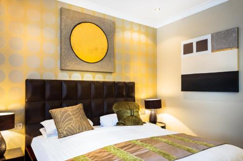 a bedroom with a bed and a yellow wall at Washington Mayfair Hotel in London