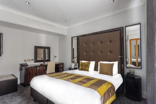 a hotel room with a large bed and a mirror at Washington Mayfair Hotel in London