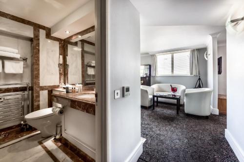 uma casa de banho com um lavatório e um WC num quarto em Washington Mayfair Hotel em Londres