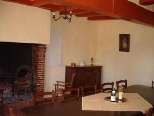 a dining room with a table and chairs and a fireplace at Gîte Berfay, 5 pièces, 11 personnes - FR-1-410-157 in Berfay