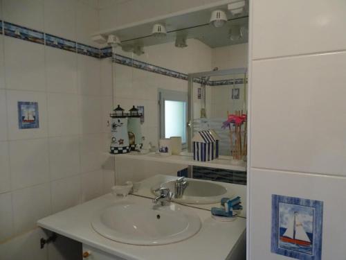 a bathroom with a sink and a mirror at Évasion rustique avec cheminée et vélos, proche du Mans - FR-1-410-166 in Congé-sur-Orne