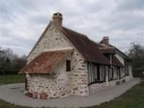 a small stone building with a brown roof at Maison à colombages rénovée en bord de forêt - FR-1-410-190 in Beauge