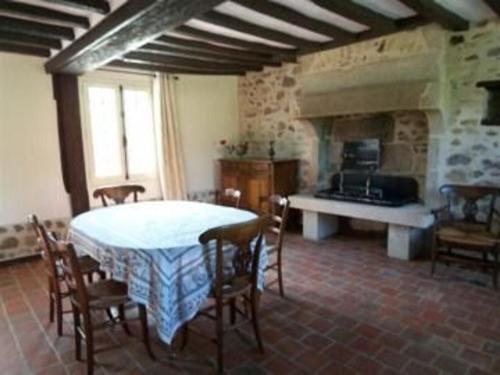 a kitchen with a table and chairs in a room at Maison à colombages rénovée en bord de forêt - FR-1-410-190 in Beauge