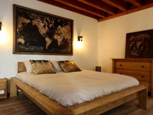 a bedroom with a bed with a map on the wall at Gîte Cérans-Foulletourte-Cérans, 2 pièces, 2 personnes - FR-1-410-273 in Cérans-Foulletourte