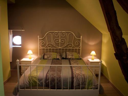 a bedroom with a bed with two lamps on both sides at Maison de campagne rénovée à 1h de Paris, avec jardin clos, 4 chambres et équipements familiaux - FR-1-590-164 in Treilles-en-Gâtinais