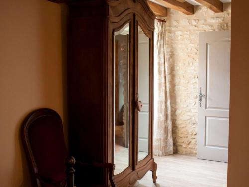 a large wooden mirror in a room with a chair at Maison de campagne rénovée à 1h de Paris, avec jardin clos, 4 chambres et équipements familiaux - FR-1-590-164 in Treilles-en-Gâtinais