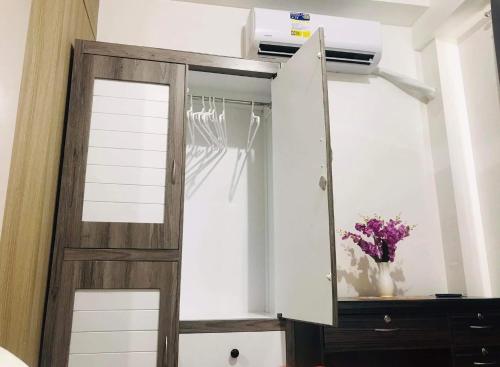 a closet with a sliding door and a dresser at Shawnalyn Condo-tel at Mall of Asia Philippines in Manila