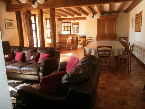 a living room with a couch and a table at Gîte spacieux avec billard, cheminée & terrasse, près de la forêt de Bercé, Wi-Fi & activités nature - FR-1-410-337 in Thoiré-sur-Dinan