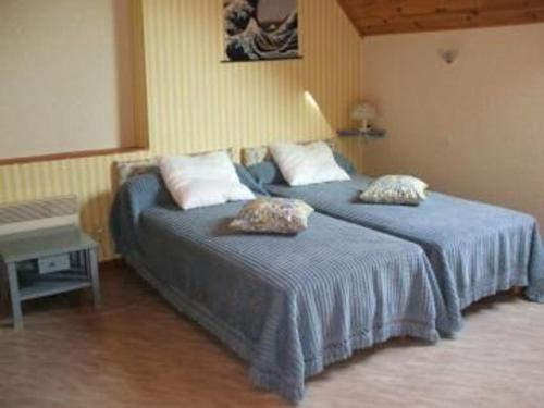 a bedroom with two beds with blue sheets and a table at Gîte spacieux avec billard, cheminée & terrasse, près de la forêt de Bercé, Wi-Fi & activités nature - FR-1-410-337 in Thoiré-sur-Dinan