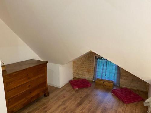 a attic room with two beds and a dresser at Château XIXème près du Mans : Piscine, Parc, Proche Forêt et Cité Médiévale - FR-1-410-354 in Parennes