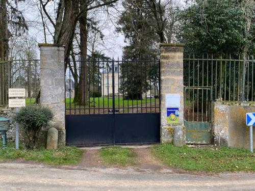a gate with a blue door in front of a fence at Château XIXème près du Mans : Piscine, Parc, Proche Forêt et Cité Médiévale - FR-1-410-354 in Parennes