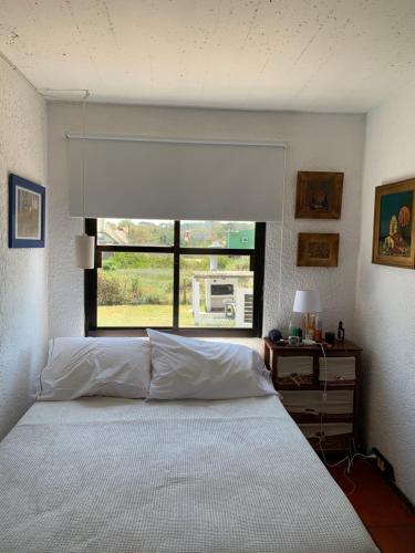 a bedroom with a large bed and a window at Balcones del Cabito 008 in La Paloma