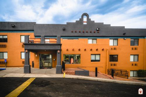 a large orange building with a street in front of it at Coyote South in Santa Fe