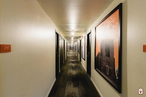 a long hallway with pictures on the walls at Coyote South in Santa Fe