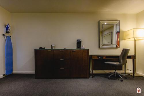 a room with a desk and a chair and a mirror at Coyote South in Santa Fe