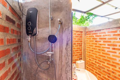 a bathroom with a shower with a phone on the wall at Bentong Wellness Resort Uphill 8Room 40Pax by Verano Homestay in Bentong
