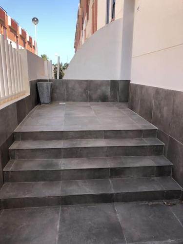 a set of stairs leading up to a building at Adosado, wifi, playa, lugar espacioso, vacacional in Grao de Castellón