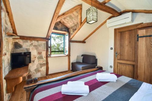 a bedroom in a tiny house with a bed and a chair at House Robinzon Sea beauty in Zastražišće