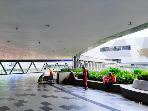 a group of people sitting in a building at i-City【CASA IMPIAN】~Wifi/Netflix/Parking~7pax in Shah Alam
