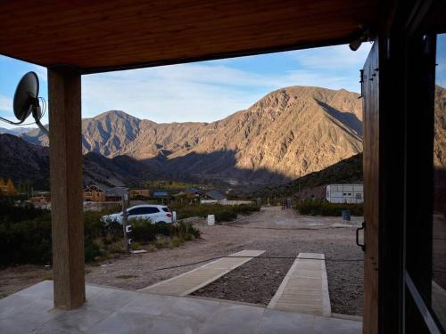 a view of a mountain range from a porch at Cumbreluz, Potrerillos in Potrerillos