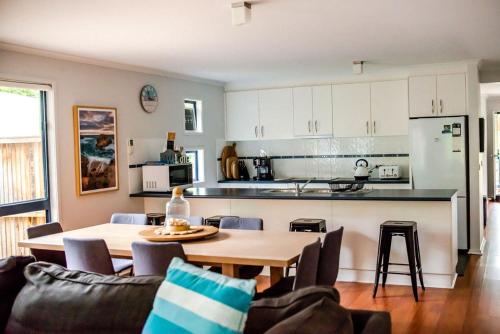 a kitchen and dining room with a table and chairs at Demure charm in Rye