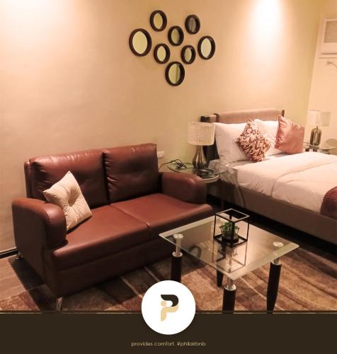 a living room with a couch and a coffee table at FULLY FURNISHED STUDIO NEAR MOA in Manila