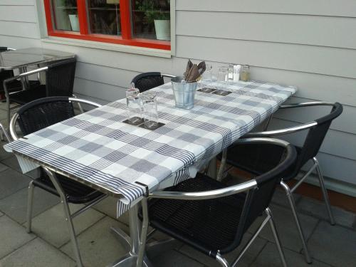 a table with chairs and a checkered table cloth at Sankt Olof Hotell & Krog in Malung