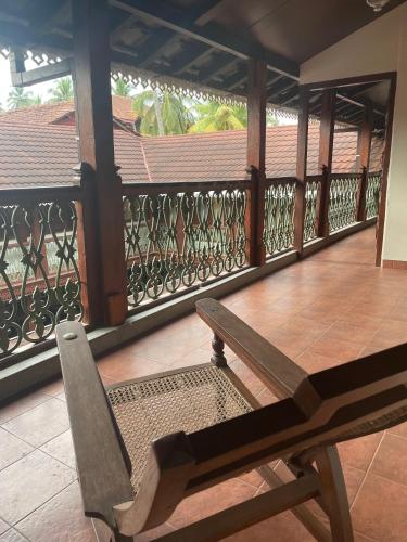 a bench sitting on a balcony with a railing at Sawantwadi Palace Boutique Art Hotel in Sawantwadi