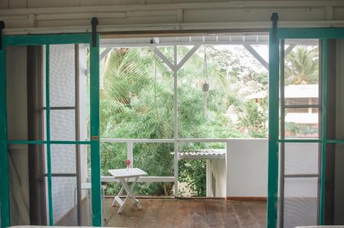 a room with a large window and a table at Casa BOHÖ in Puerto Viejo