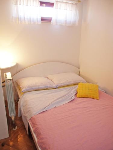 a bed in a room with a window at Family Friendly Apartments in Pula