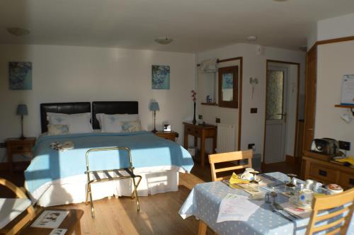 a bedroom with a bed and a table and chairs at Smithfield Farm Bed & Breakfast in Builth Wells