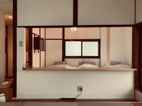 a room with two beds on a wall at Bird Place log Tokyo #KS1 in Tokyo