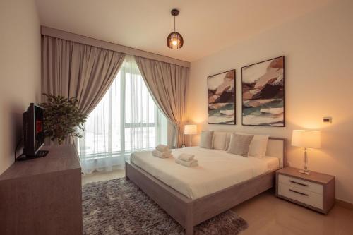 Säng eller sängar i ett rum på Signature Burj Khalifa And Fountain View Residence