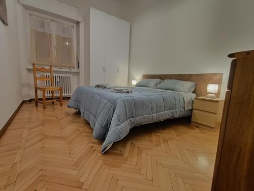 a bedroom with a bed and a wooden floor at MountainAosta - CIR 0062 in Aosta