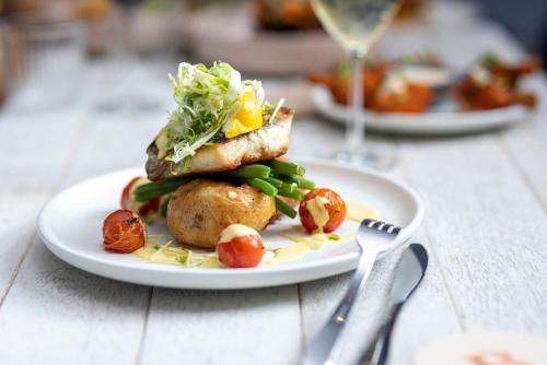 a plate of food with vegetables on a table at Bribie Island Hotel in Bellara