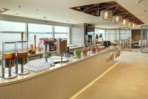 a large kitchen with a counter with drinks on it at Crowne Plaza Dhaka Gulshan by IHG in Dhaka