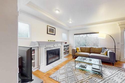 a living room with a couch and a fireplace at Woodlawn Escape in Seattle