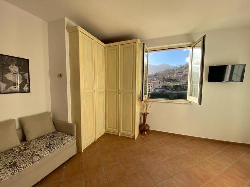 salon z dużym oknem i kanapą w obiekcie Chez Luke Apartments in Agerola w mieście Agerola