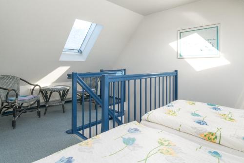 a bedroom with two beds and a table and chairs at null Haus Frisia, Whg 407 in Sankt Peter-Ording