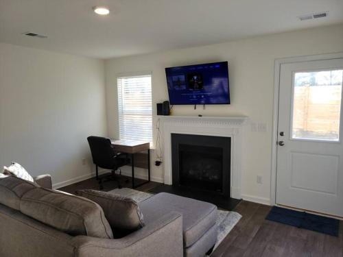 a living room with a couch and a fireplace at SC 3745 New Townhouse Ft Jackson & USC in Columbia